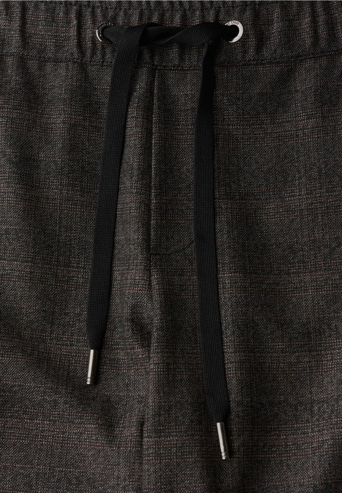 Dark gray pants with a drawstring on a matching fabric background