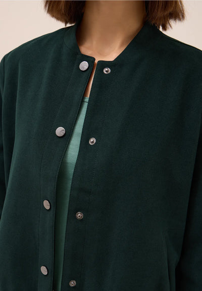 Close-up of a dark green jacket with buttons on a neutral background