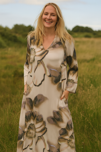 Woman wearing a floral dress standing in a field