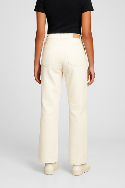 Person wearing beige pants and a black top on a light gray background