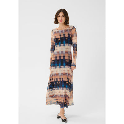 Woman wearing a tie-dye dress on a white background