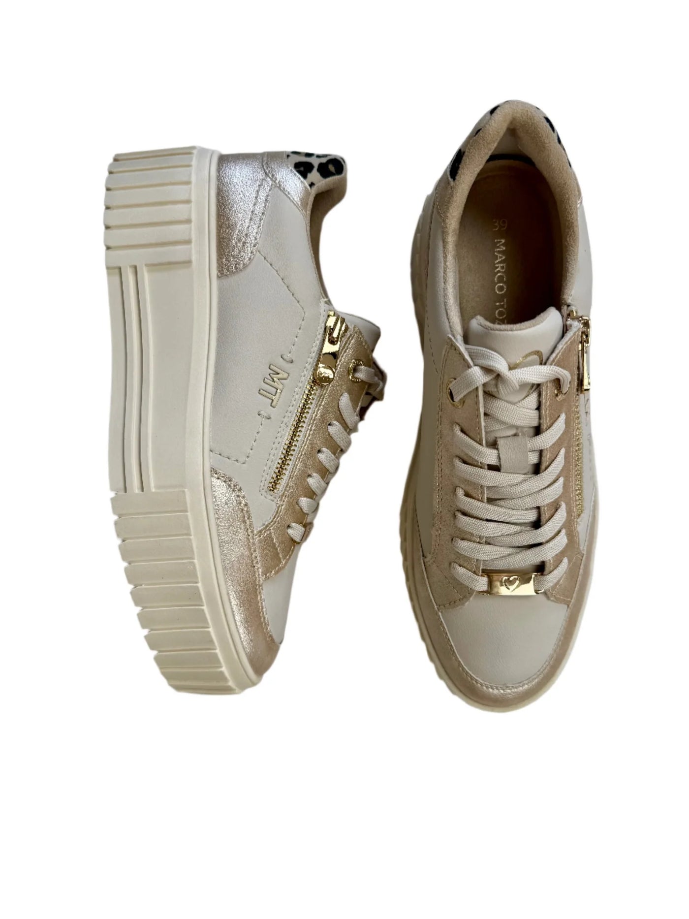 Pair of beige sneakers with gold accents on a white background