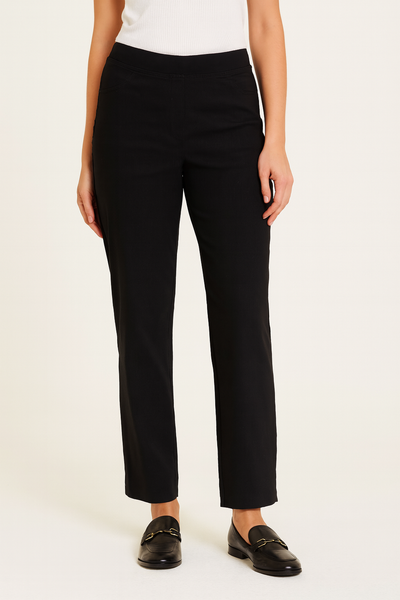 Person wearing black pants and black shoes on a white background