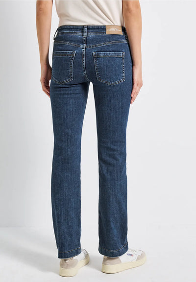 Person wearing blue jeans on a white background