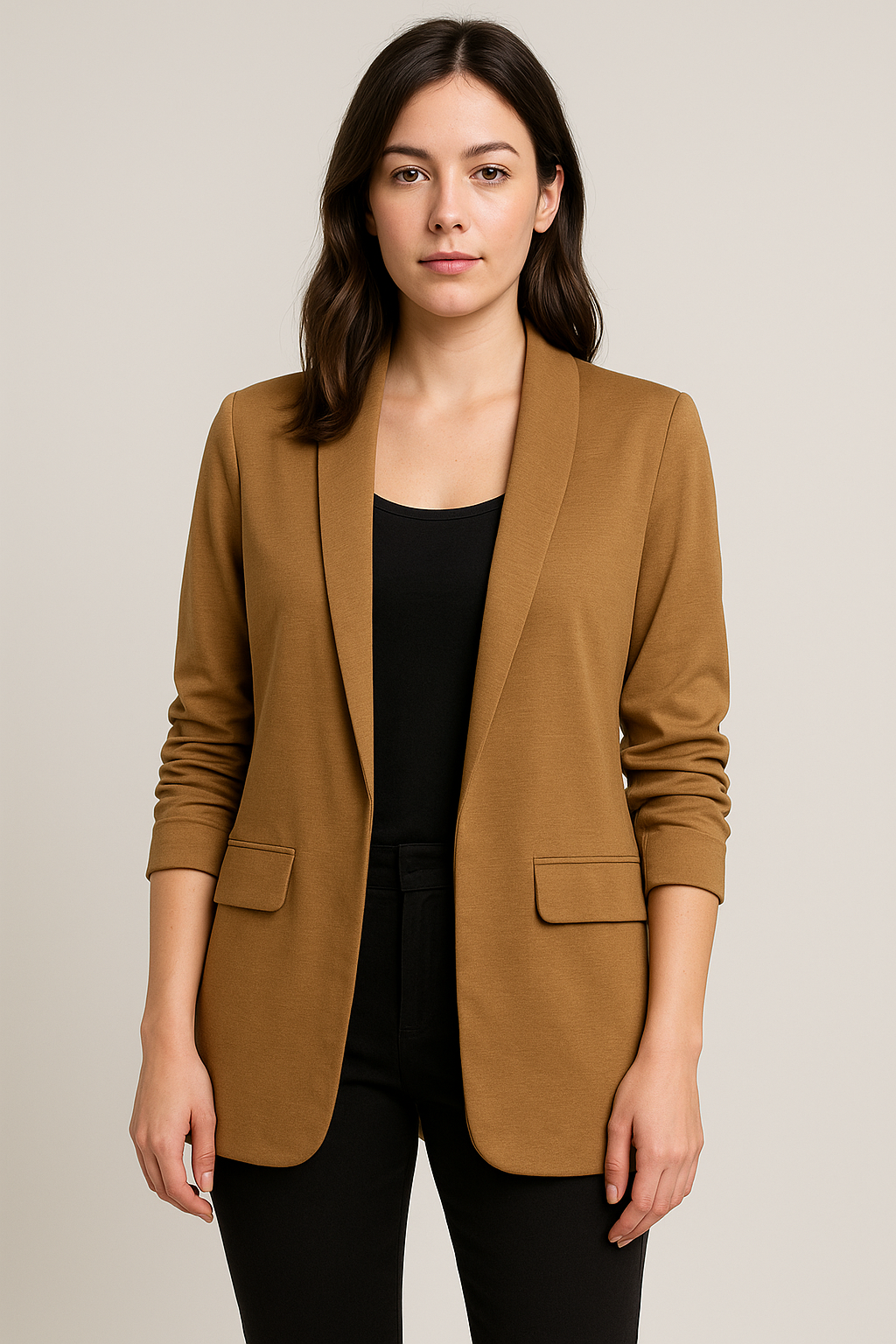Woman wearing a brown blazer over a black top on a beige background