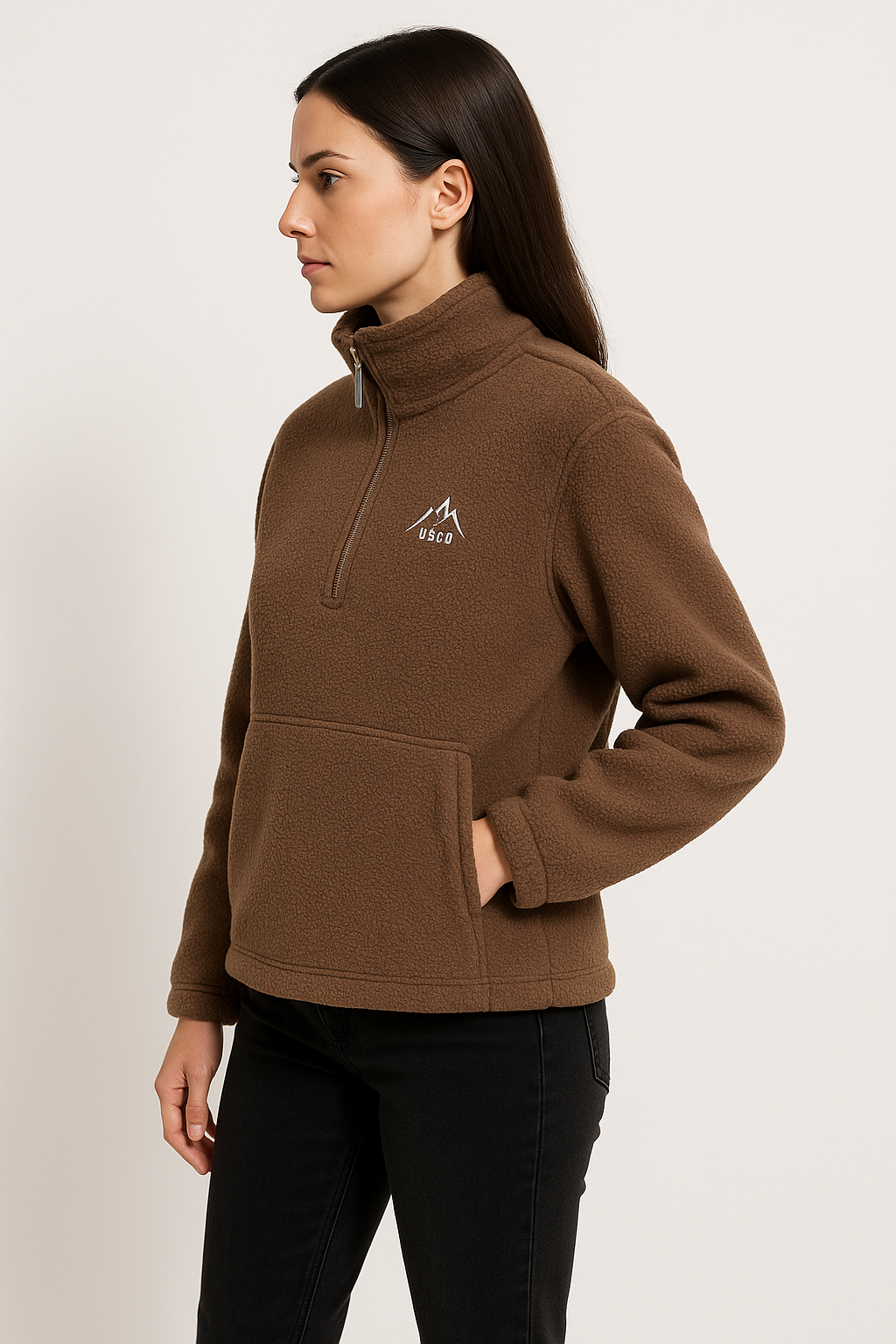 Woman wearing a brown fleece pullover with a logo on a white background