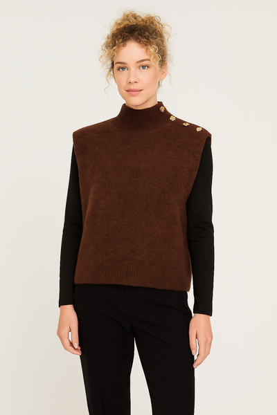 Woman wearing a brown vest over a black long-sleeve shirt on a white background
