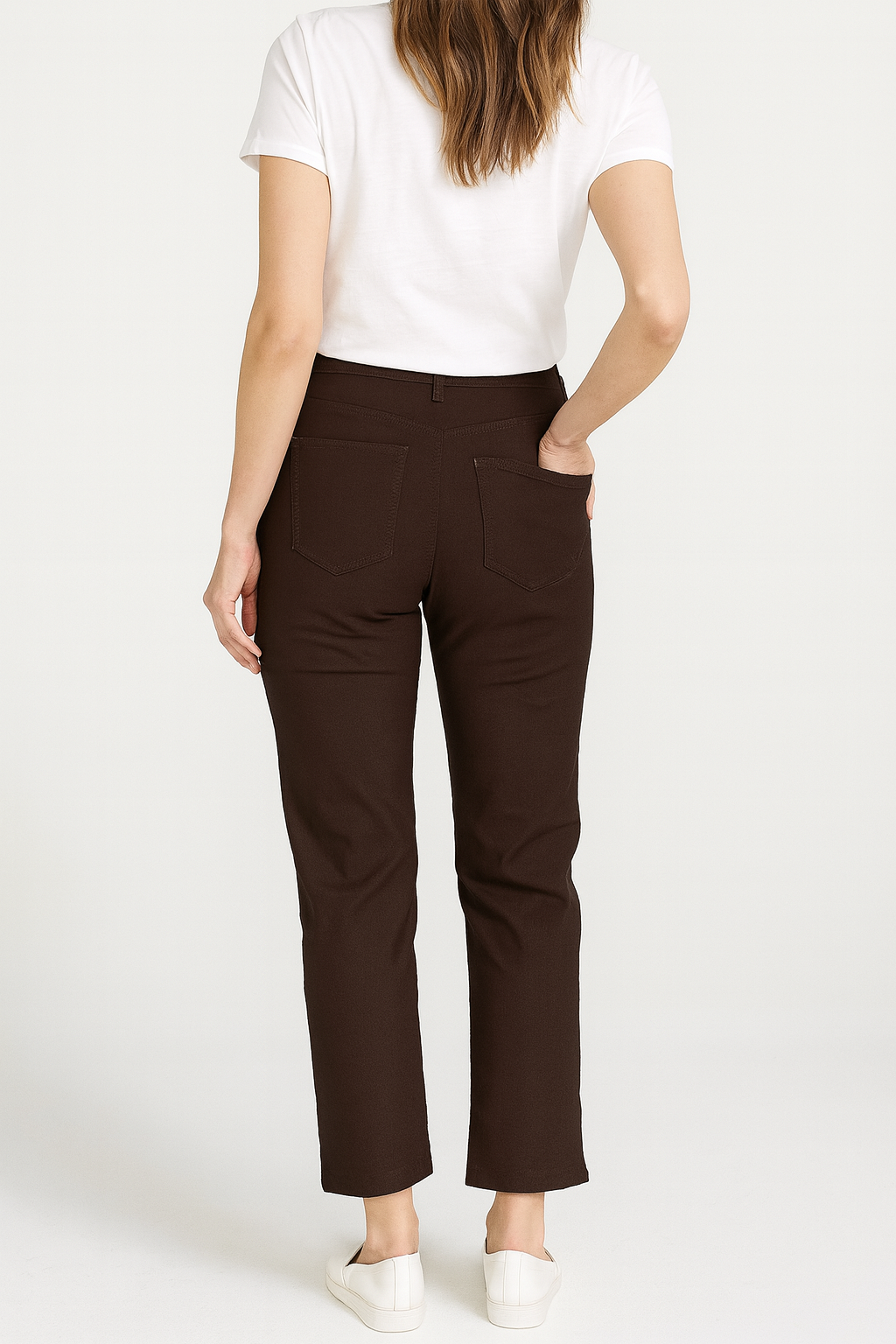 Person wearing brown pants and a white shirt on a white background