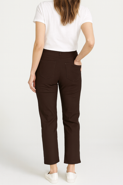 Person wearing brown pants and a white shirt on a white background