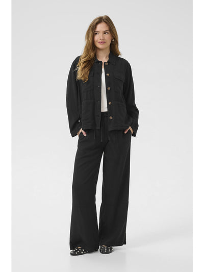 Woman wearing a black outfit with a white background