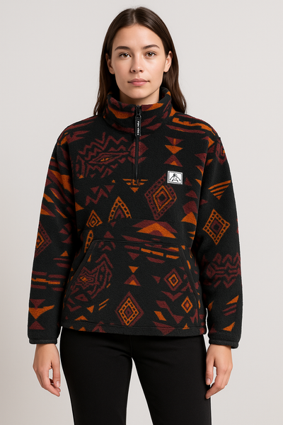 Person wearing a black and orange patterned pullover with a visible brand logo on a white background