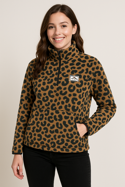 Woman wearing a leopard print fleece jacket with a logo on a beige background