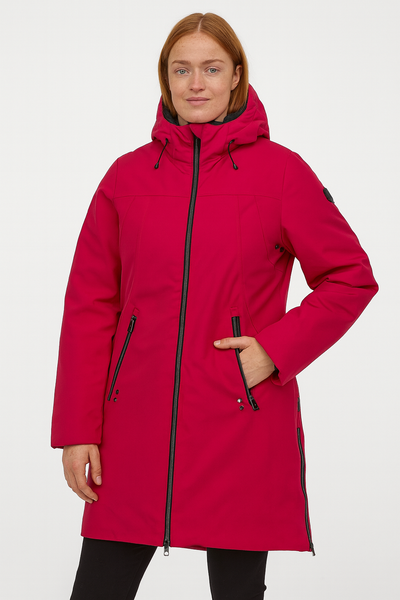Woman wearing a pink coat with black accents on a white background