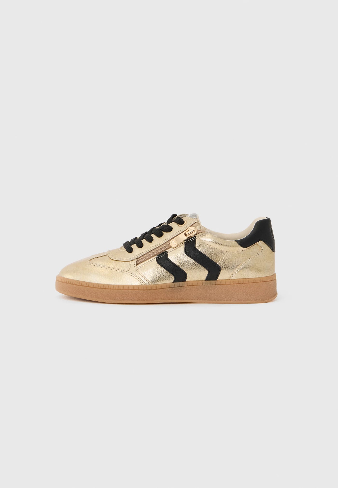 Gold sneaker with black accents on a light gray background