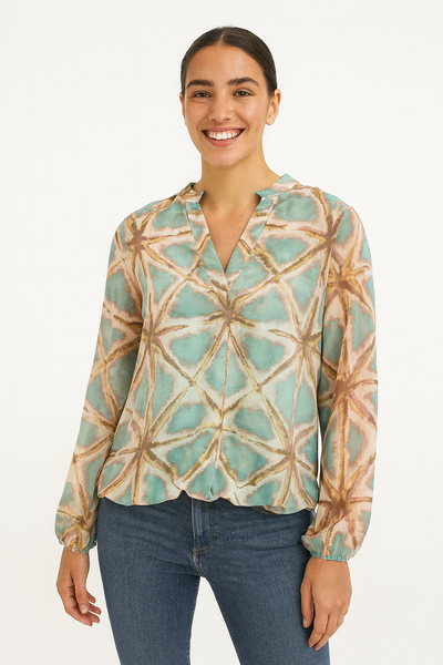 Woman wearing a long-sleeve top with a geometric pattern on a white background