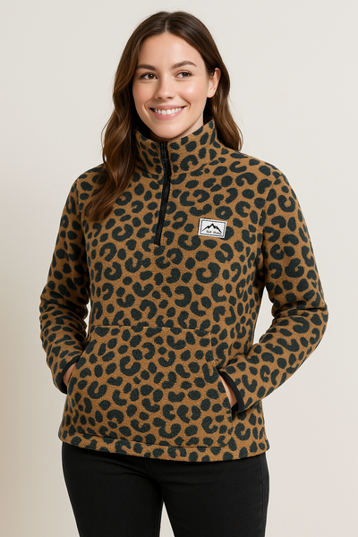 Woman wearing a leopard print pullover with a logo on a beige background