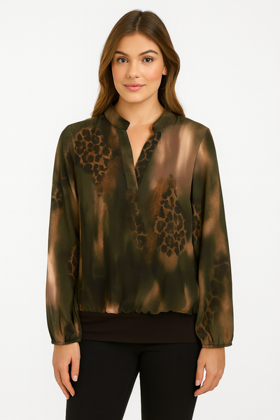 Woman wearing a green blouse with leopard print details on a white background