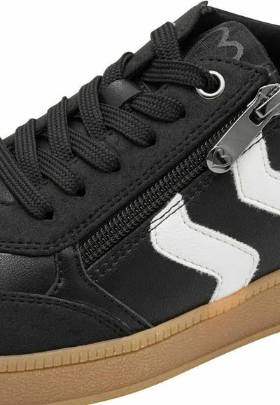 Black sneaker with white zigzag pattern and visible zipper on a white background