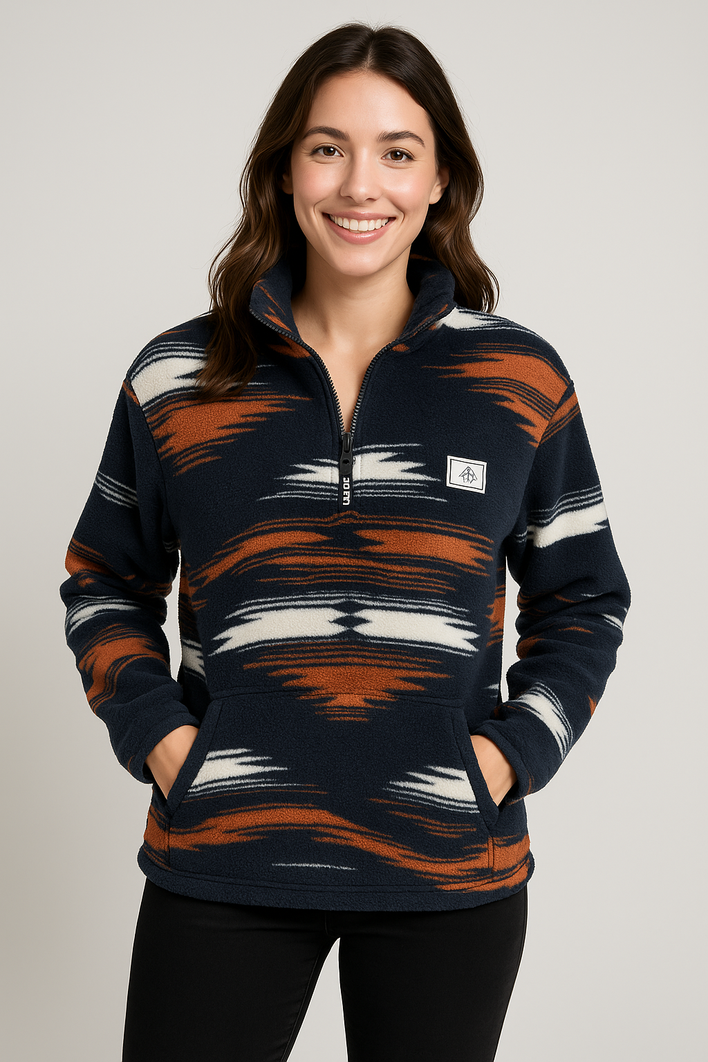Woman wearing a patterned pullover with a neutral background