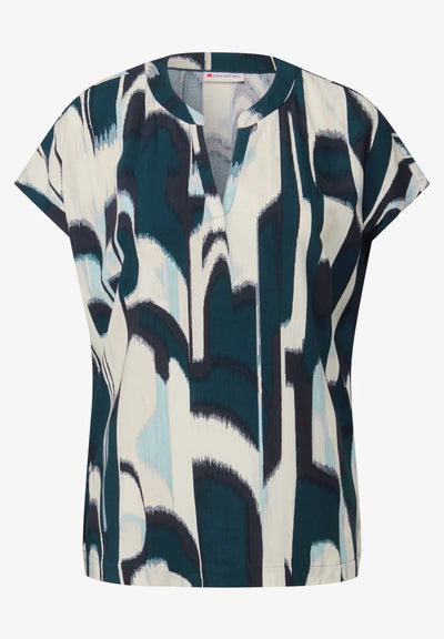 Short-sleeve blouse with abstract pattern on a white background