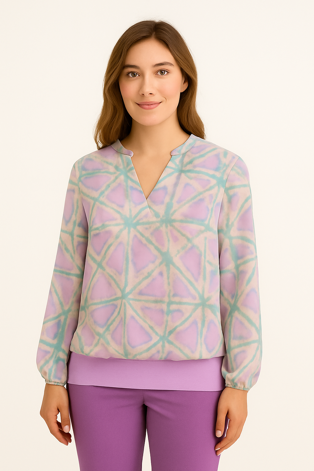 Woman wearing a pastel patterned top and purple pants on a beige background