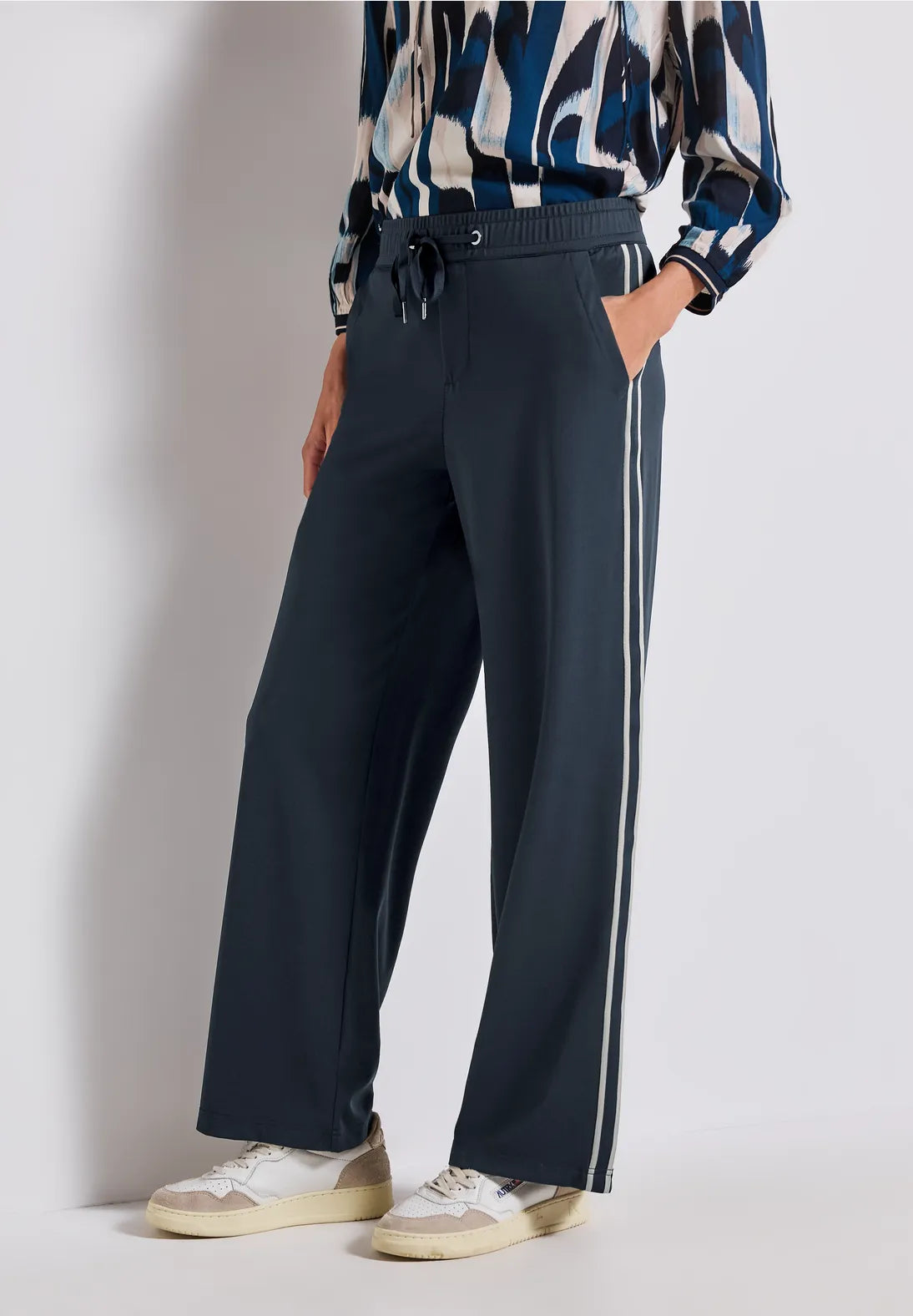 Person wearing dark pants with a white background