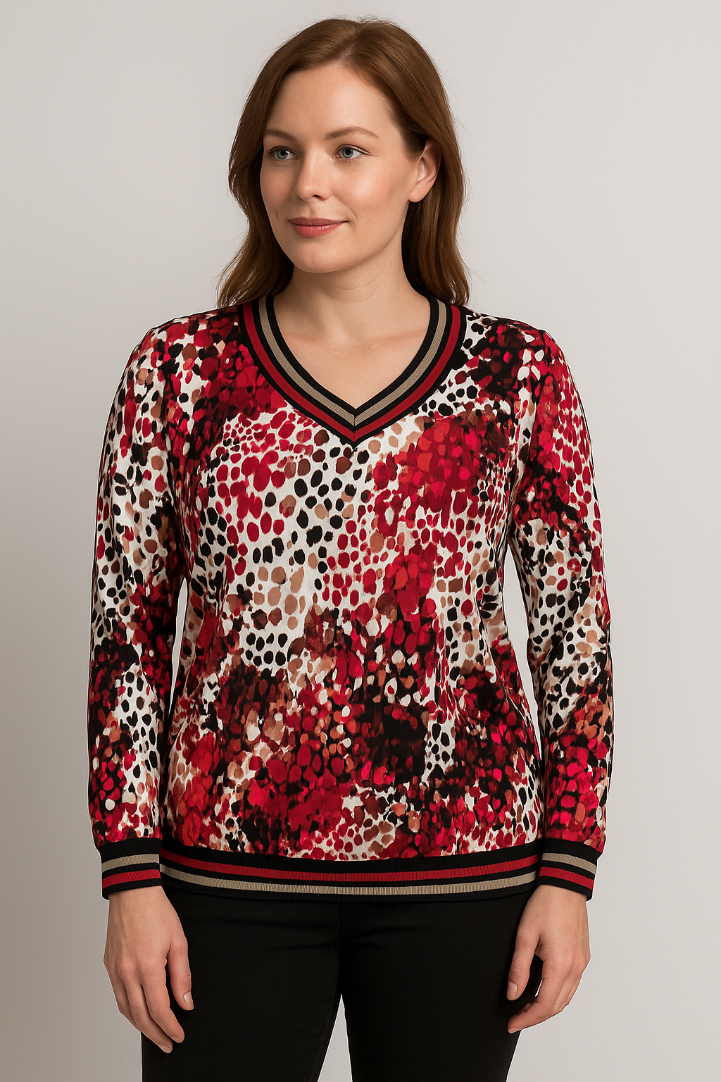 Woman wearing a red and black patterned sweater on a gray background